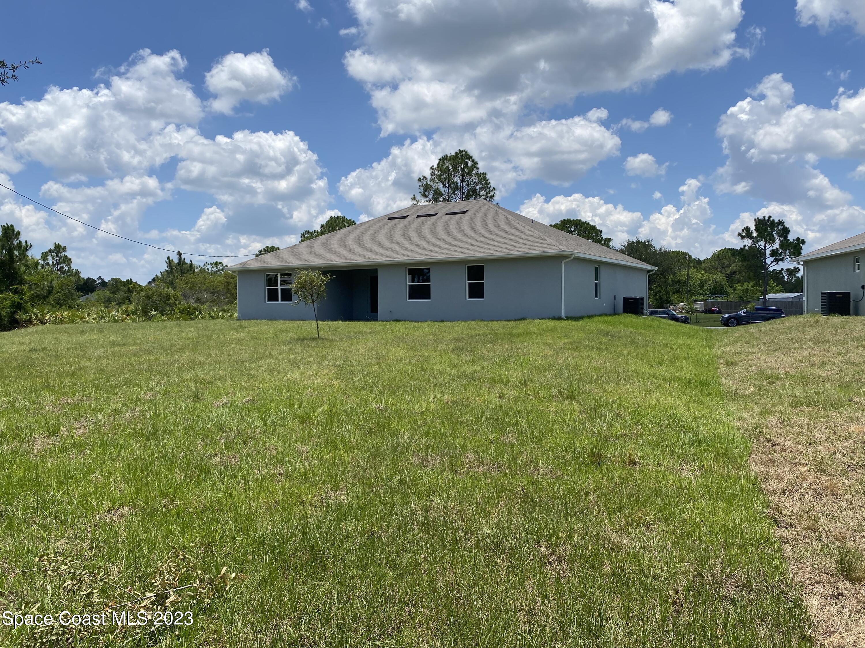 1295 Ragen Road Southeast Palm Bay, FL 32909 - Photo 6 of 44 a view of a house with a yard