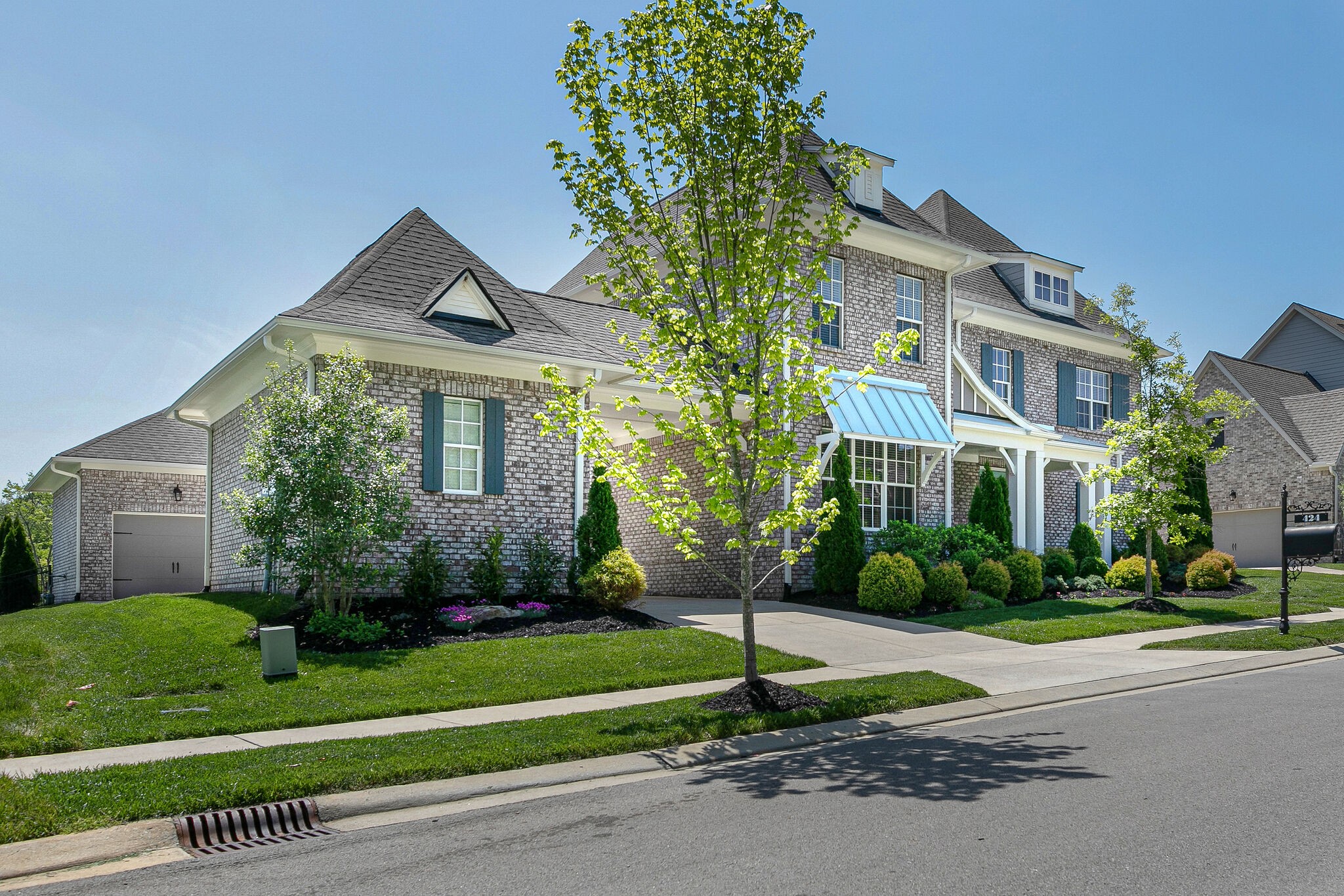 424 Beamon Drive Franklin, TN 37064 - Photo 3 of 52 a front view of a house with a yard and potted plants