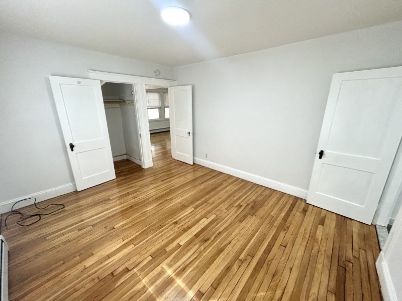 119 Bailey Road, Unit 1 Somerville, MA 02145 - Photo 11 of 25 a view of a room with wooden floor and stairs