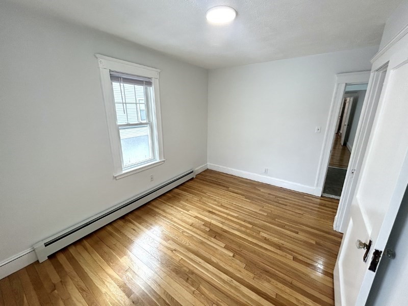 119 Bailey Road, Unit 1 Somerville, MA 02145 - Photo 15 of 25 a view of empty room with wooden floor and fan