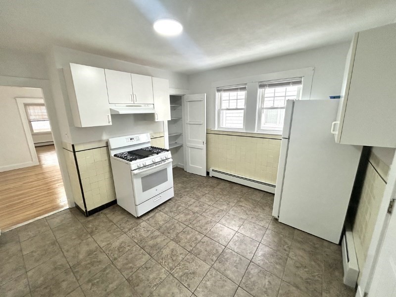 119 Bailey Road, Unit 1 Somerville, MA 02145 - Photo 17 of 25 a kitchen with stainless steel appliances a refrigerator sink and cabinets