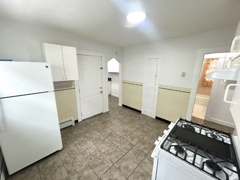 119 Bailey Road, Unit 1 Somerville, MA 02145 - Photo 20 of 25 a kitchen with refrigerator and cabinets