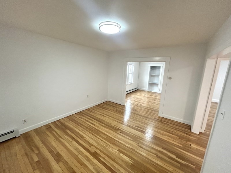 119 Bailey Road, Unit 1 Somerville, MA 02145 - Photo 2 of 25 a view of a room with wooden floor and window