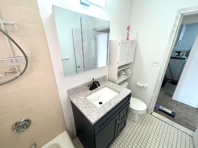 119 Bailey Road, Unit 1 Somerville, MA 02145 - Photo 23 of 25 a bathroom with a sink toilet and shower