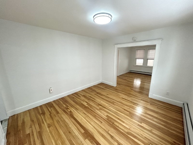 119 Bailey Road, Unit 1 Somerville, MA 02145 - Photo 7 of 25 wooden floor in an empty room