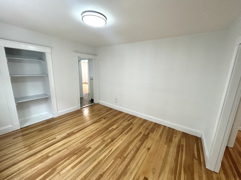 119 Bailey Road, Unit 1 Somerville, MA 02145 - Photo 8 of 25 a view of an empty room and wooden floor