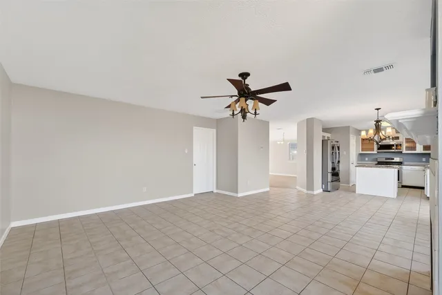 a view of a kitchen with kitchen island wooden floor and window