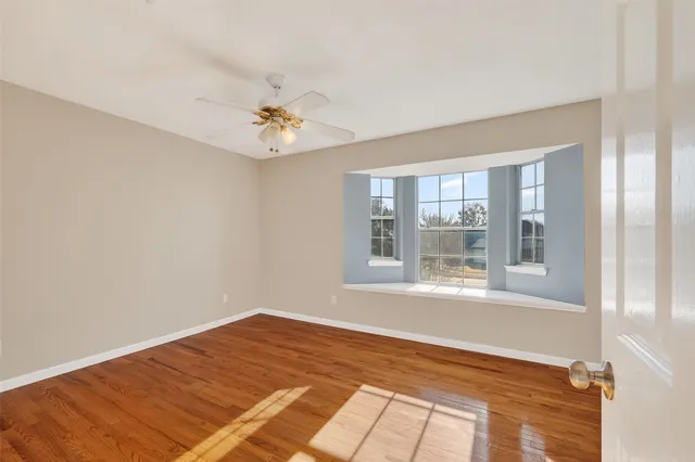 a bedroom with a bed and a chandelier fan