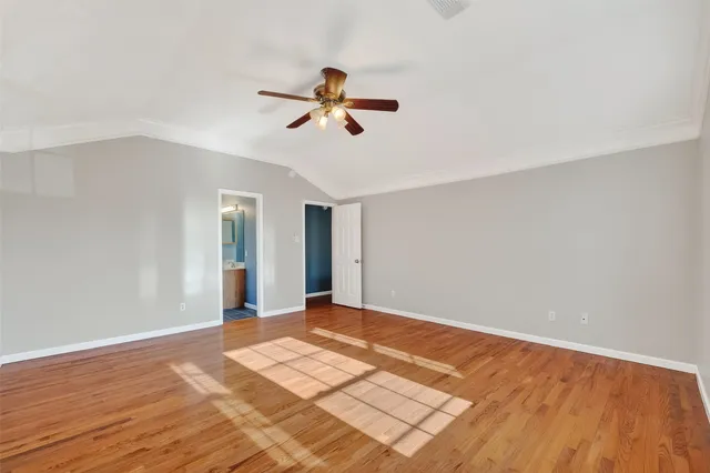 a view of a room with wooden floor and bathroom