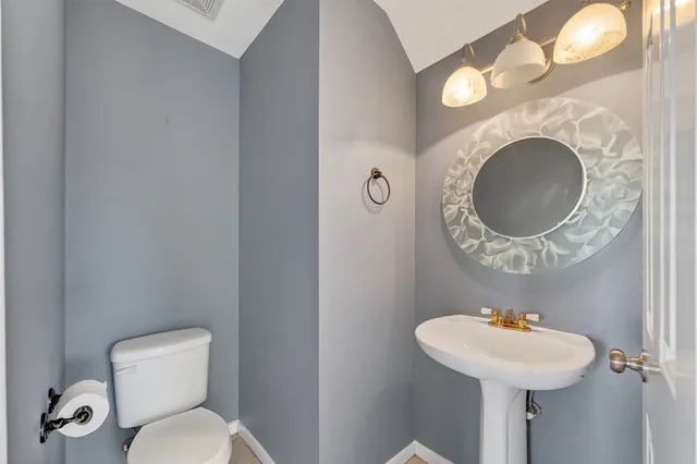 an empty room with windows and fireplace