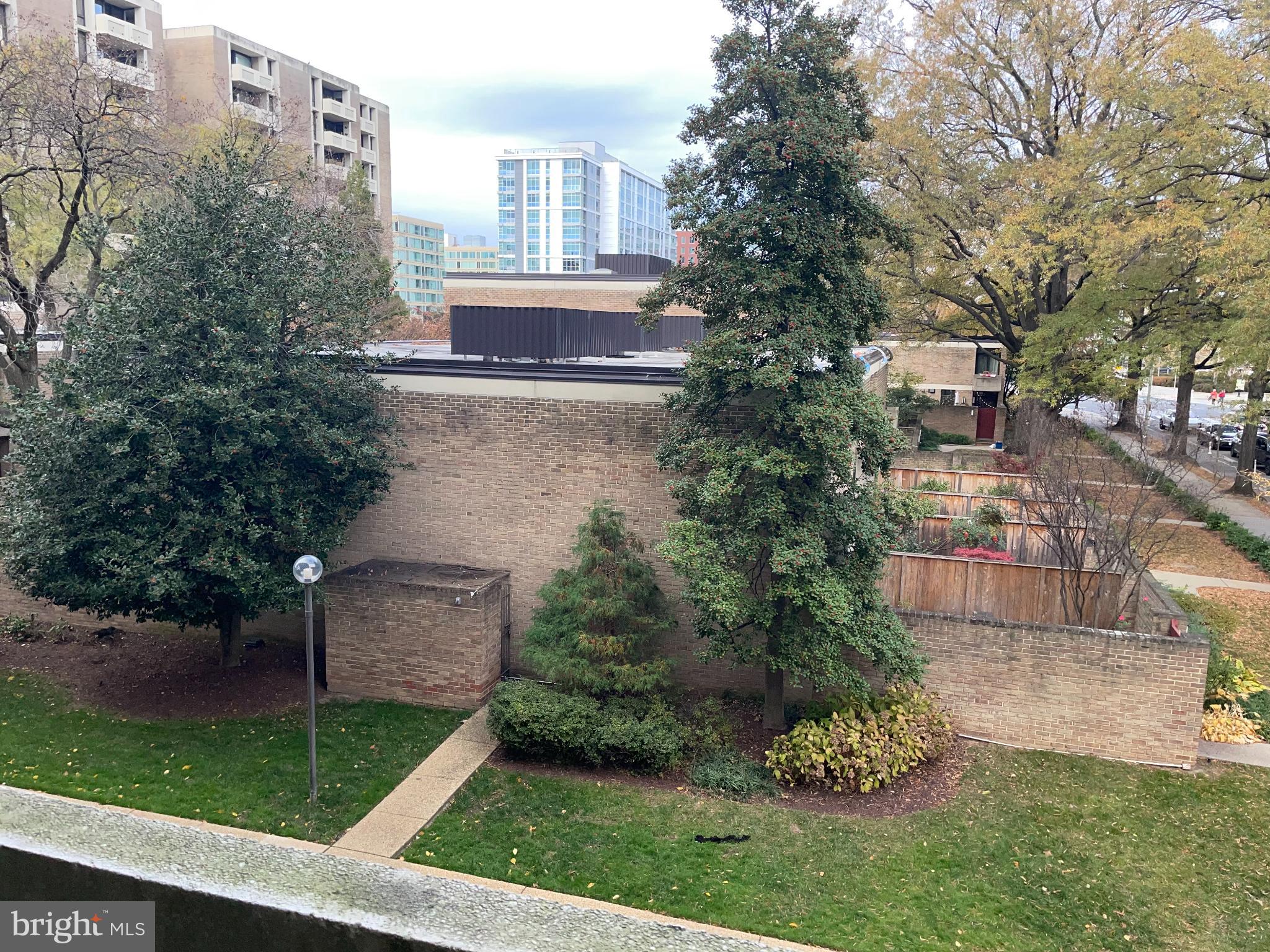 1245 4th Street Southwest, Unit E108 Washington, DC 20024 - Photo 16 of 16 a view of a house with a yard and a garden