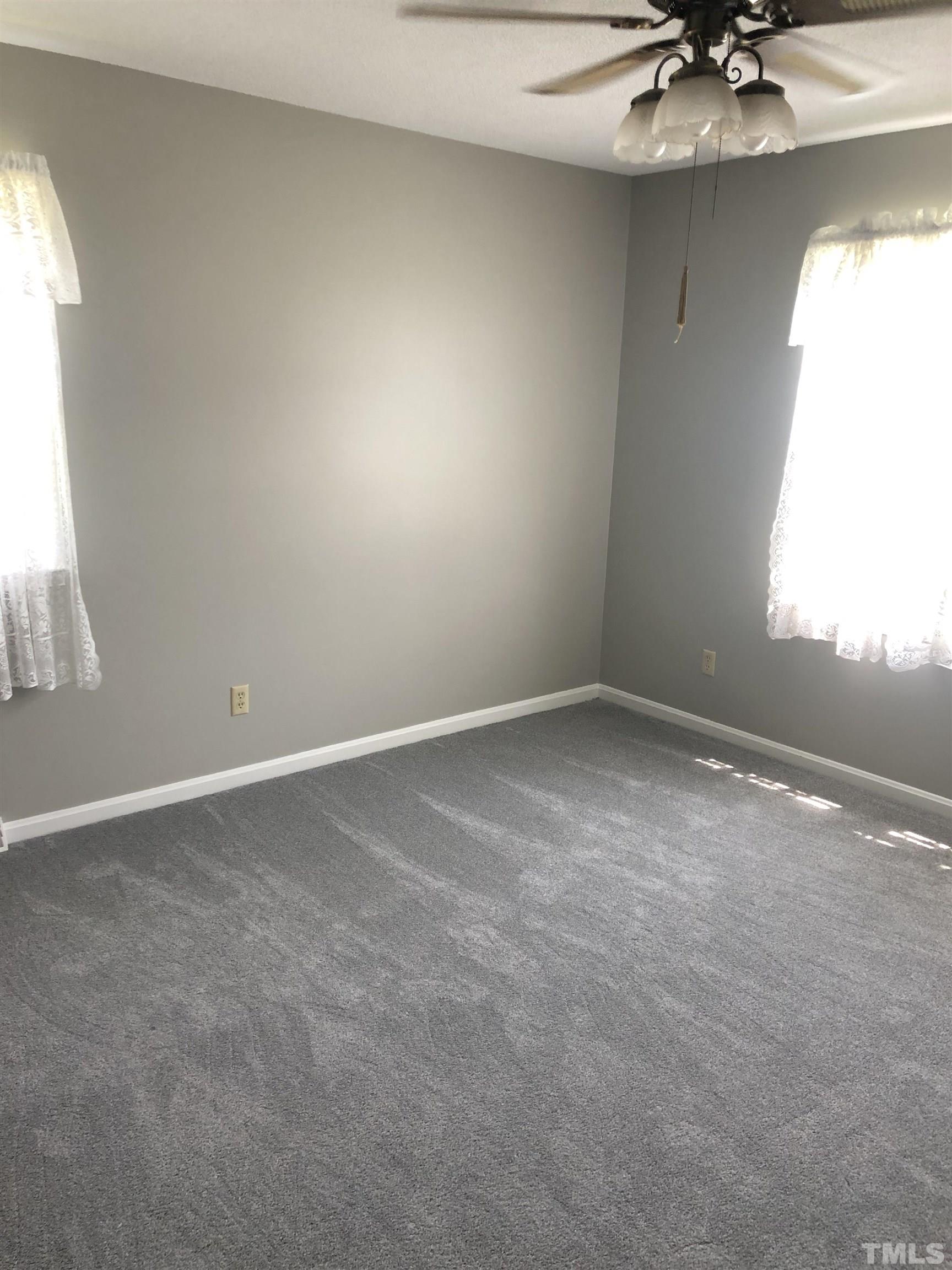 927 Junction Road Durham, NC 27704 - Photo 12 of 22 an empty room with a window and a ceiling fan