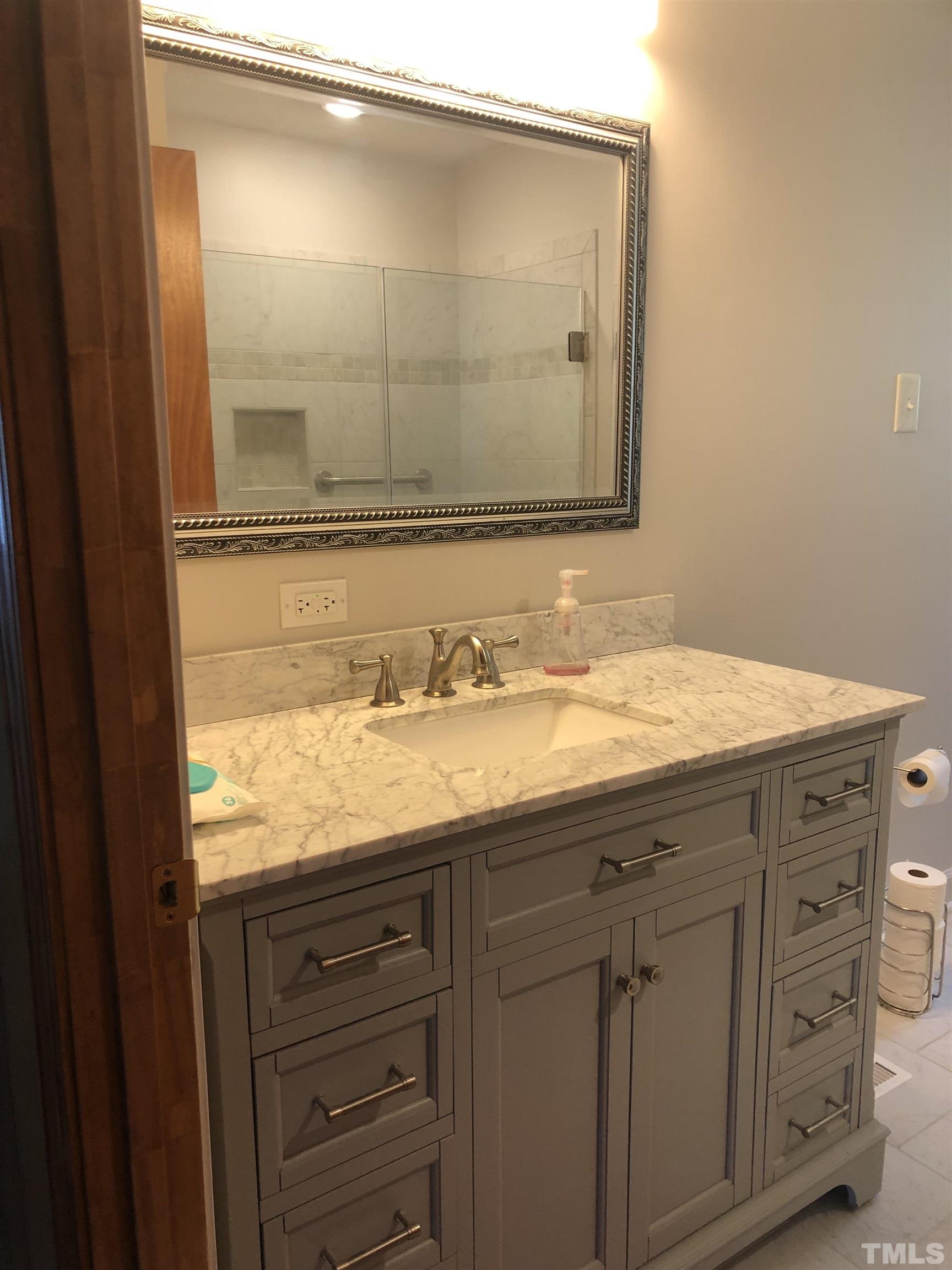 927 Junction Road Durham, NC 27704 - Photo 13 of 22 a bathroom with a granite countertop sink and a mirror