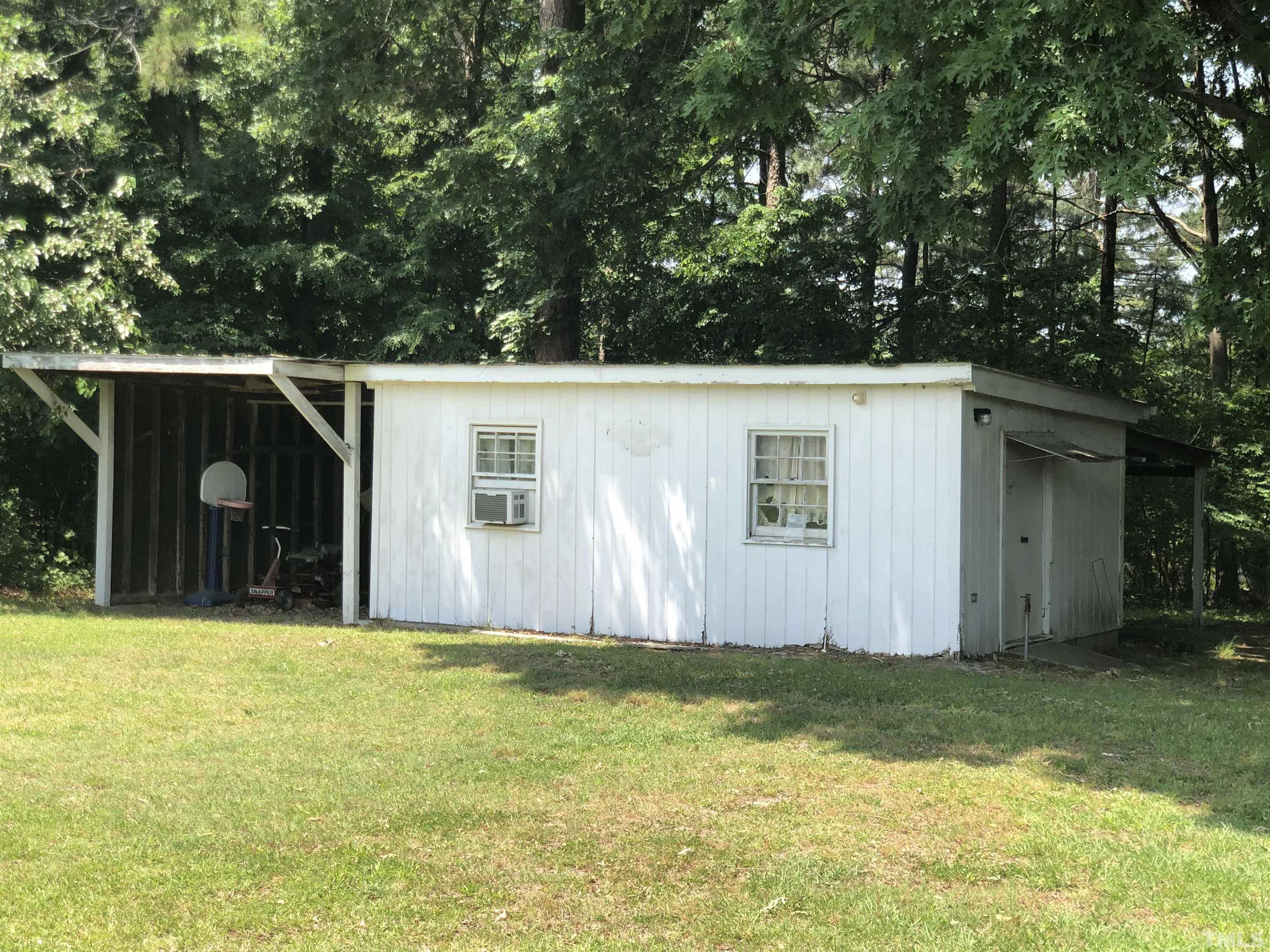 927 Junction Road Durham, NC 27704 - Photo 16 of 22 a view of a house with backyard and trees