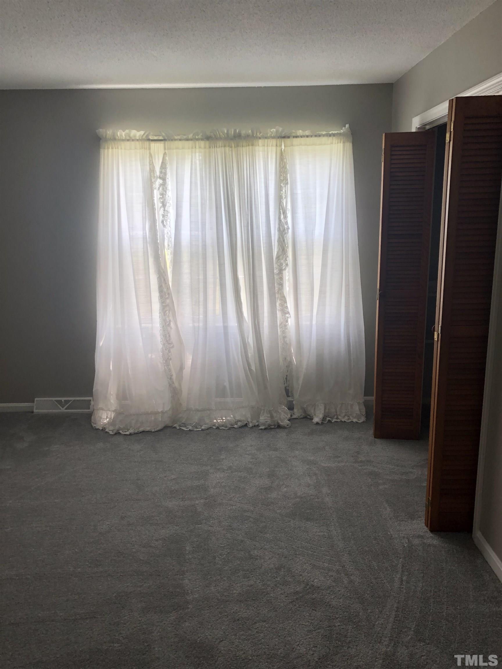 927 Junction Road Durham, NC 27704 - Photo 18 of 22 an empty room with windows