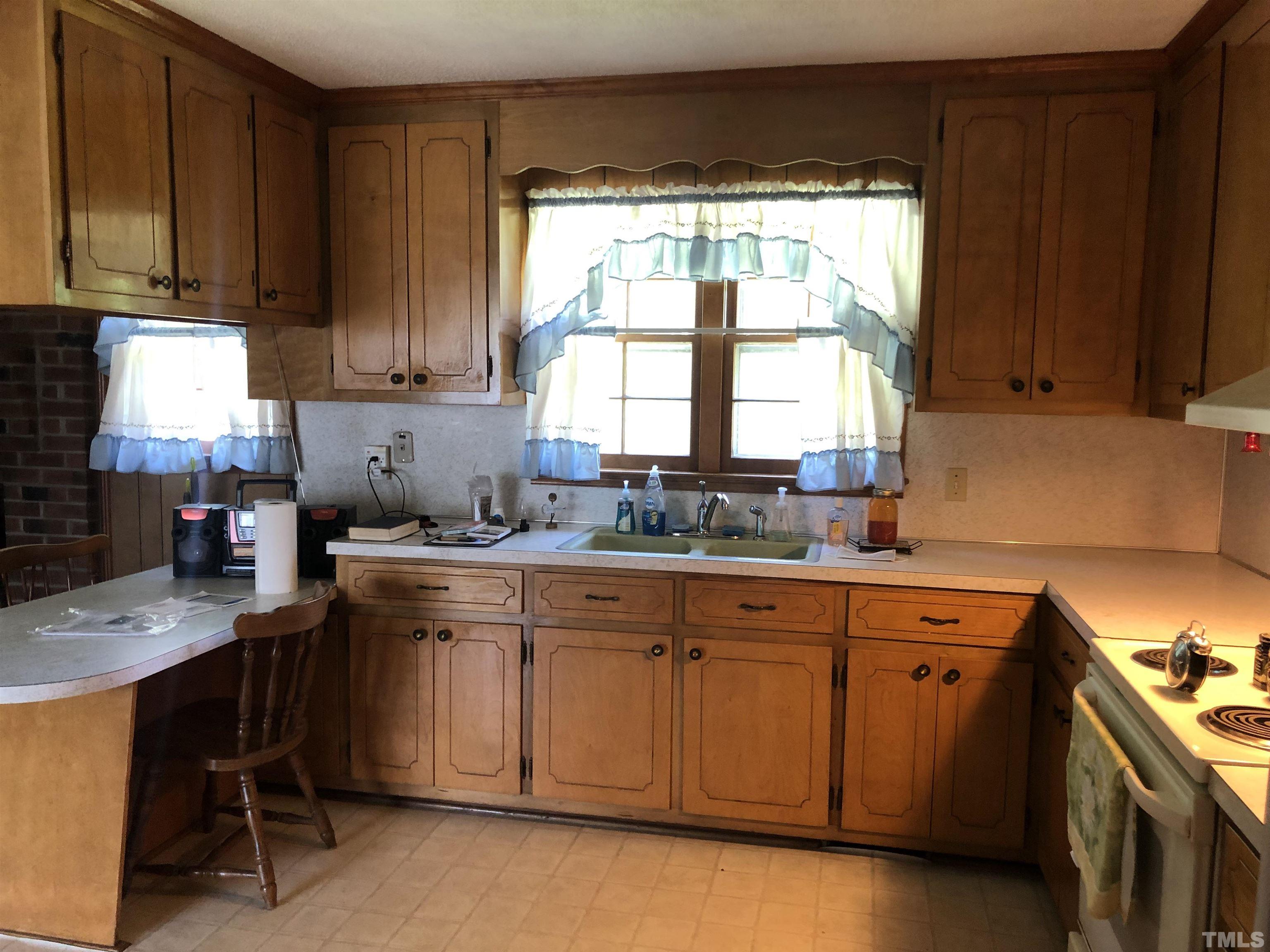 927 Junction Road Durham, NC 27704 - Photo 19 of 22 a kitchen with a sink window and cabinets