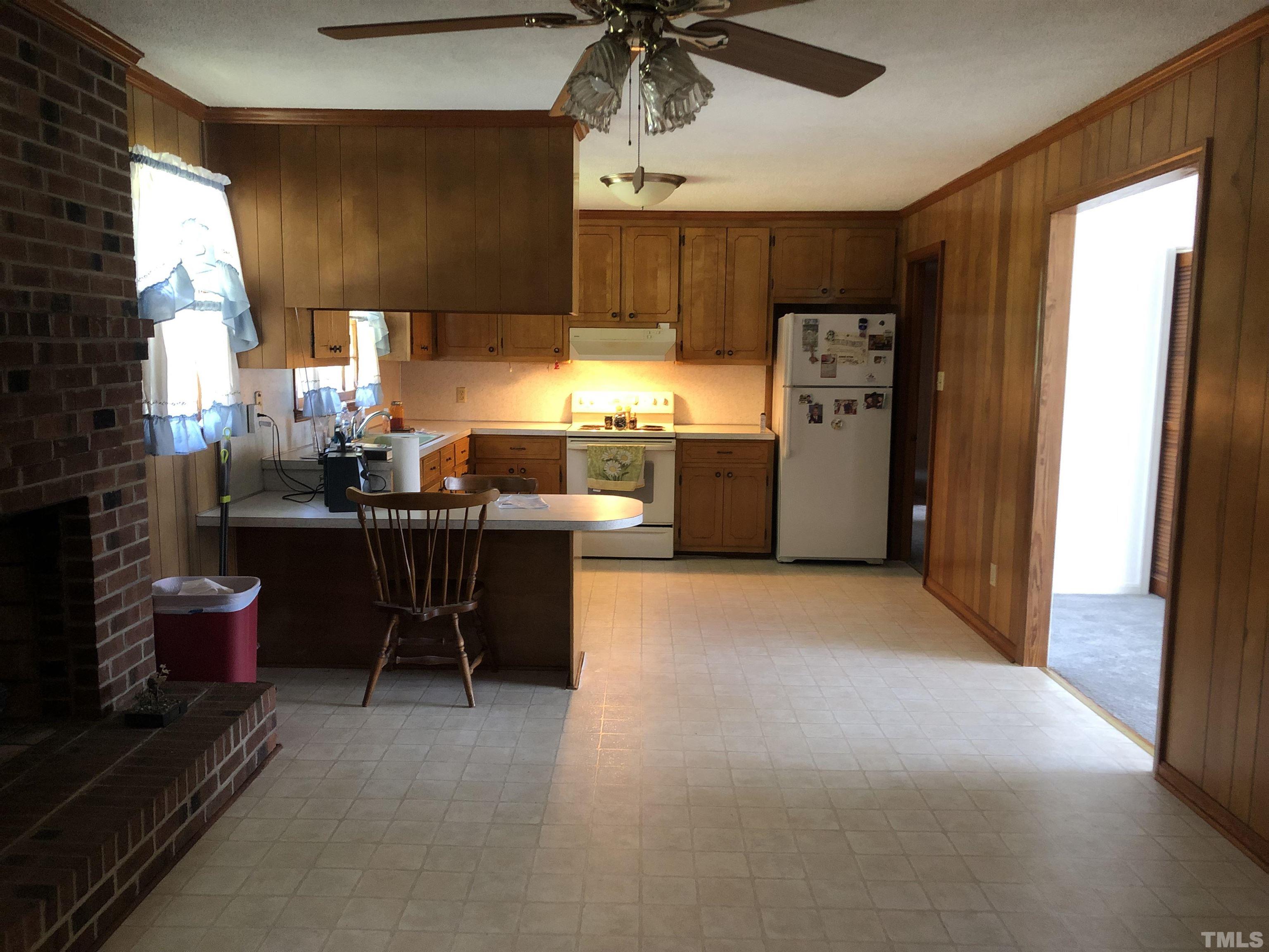 927 Junction Road Durham, NC 27704 - Photo 20 of 22 a kitchen with refrigerator and chairs