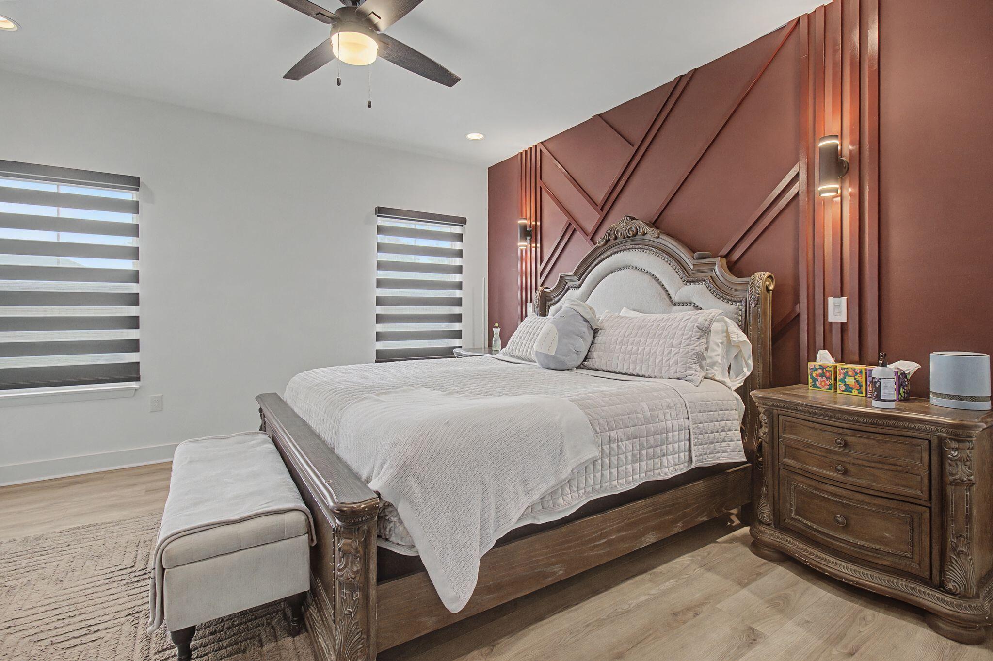 197 West 1st Avenue Crestview, FL 32536 - Photo 16 of 32 a bedroom with a bed and dresser with mirror