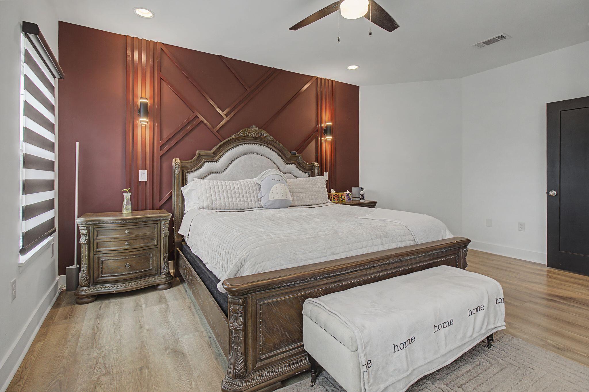 197 West 1st Avenue Crestview, FL 32536 - Photo 17 of 32 a bedroom with a bed and a dresser with wooden floor