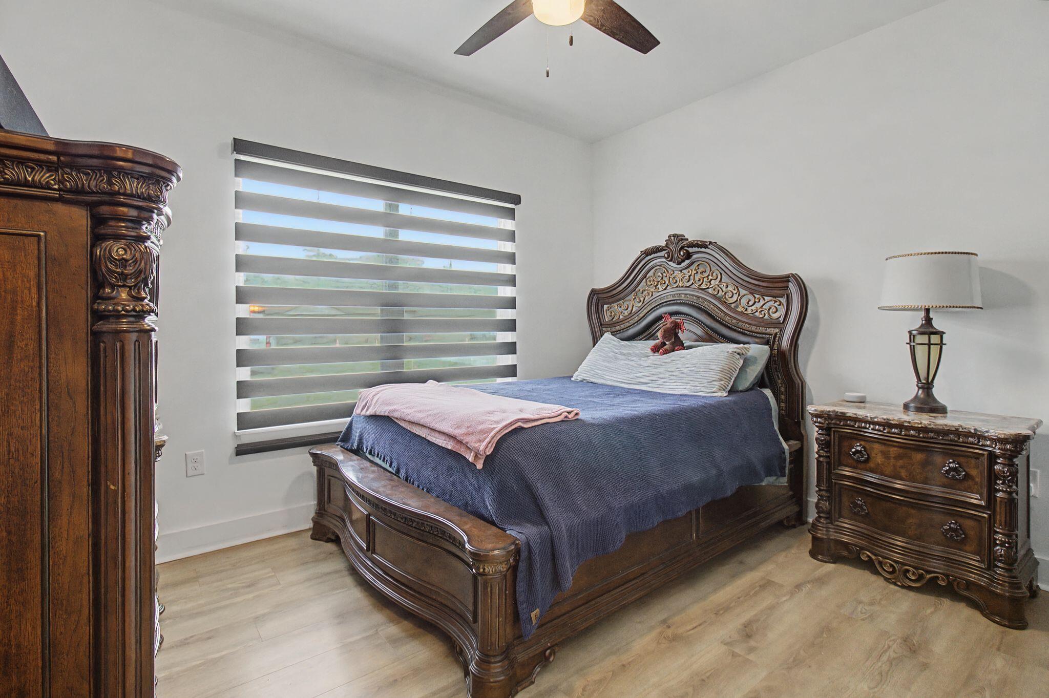 197 West 1st Avenue Crestview, FL 32536 - Photo 21 of 32 a bedroom with a bed and a dresser