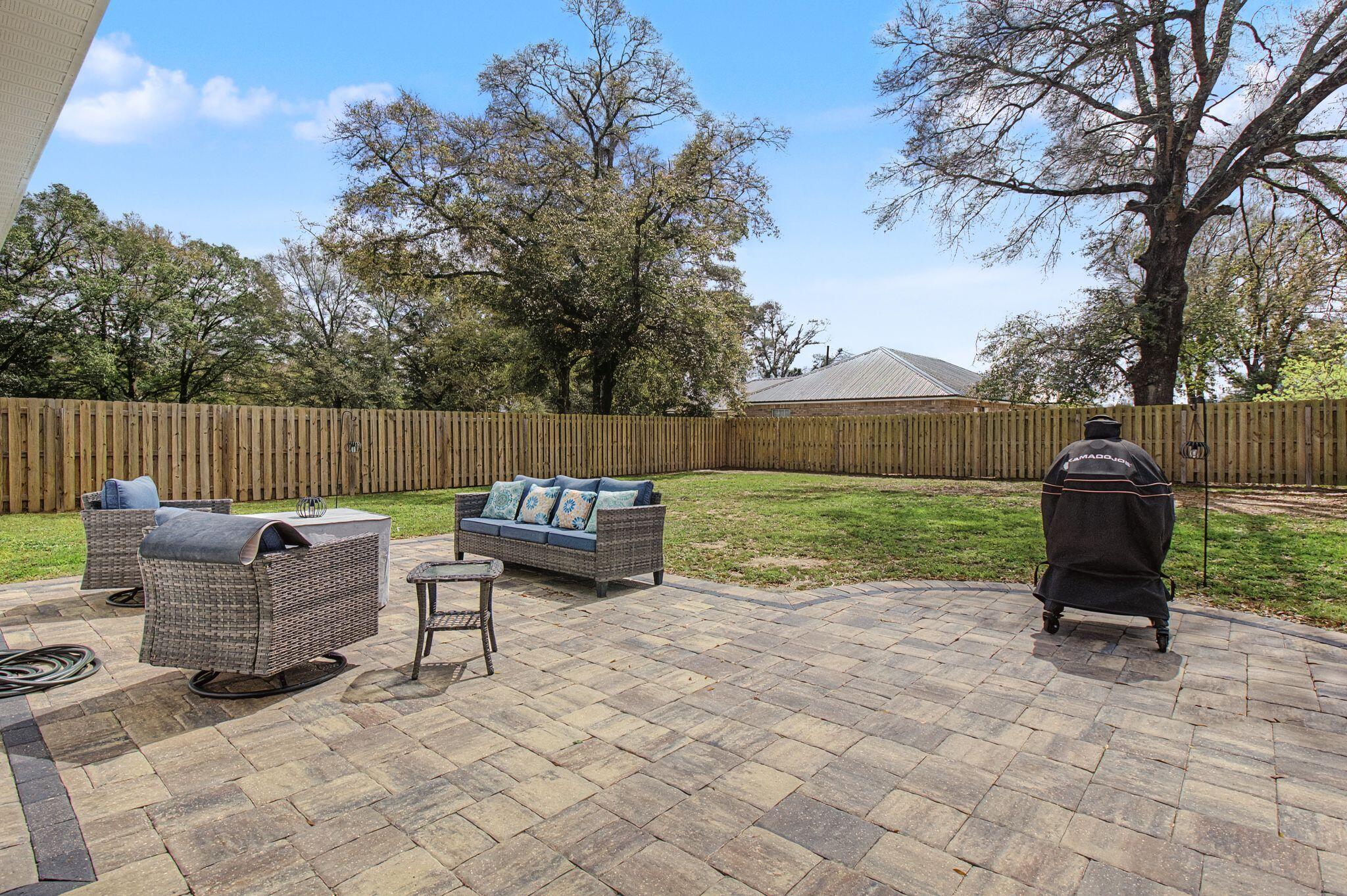 197 West 1st Avenue Crestview, FL 32536 - Photo 25 of 32 a view of backyard with seating space and trees