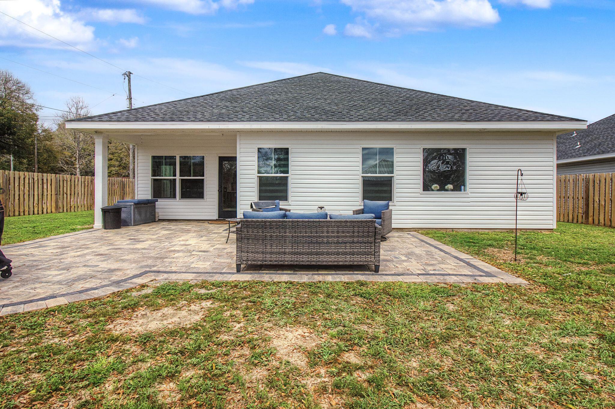 197 West 1st Avenue Crestview, FL 32536 - Photo 27 of 32 a view of a house with a yard and sitting area