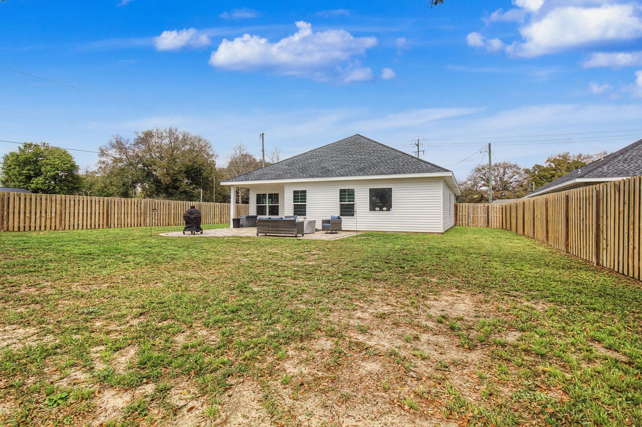 197 West 1st Avenue Crestview, FL 32536 - Photo 29 of 32 a front view of a house with a yard
