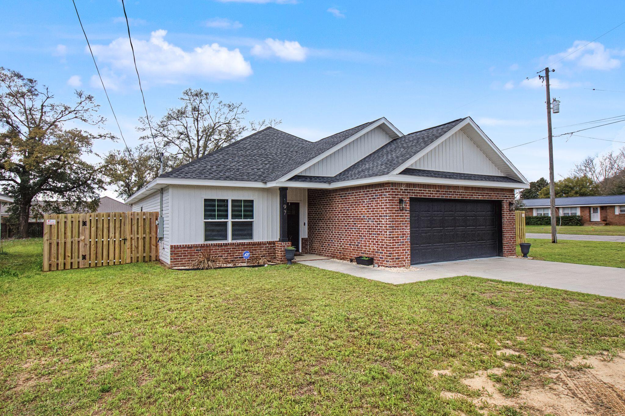 197 West 1st Avenue Crestview, FL 32536 - Photo 3 of 32 a front view of a house with a yard and garage