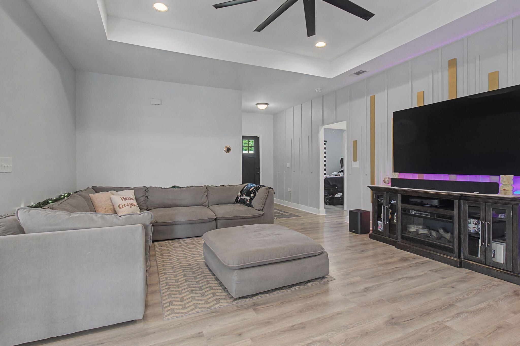 197 West 1st Avenue Crestview, FL 32536 - Photo 7 of 32 a living room with furniture and a flat screen tv