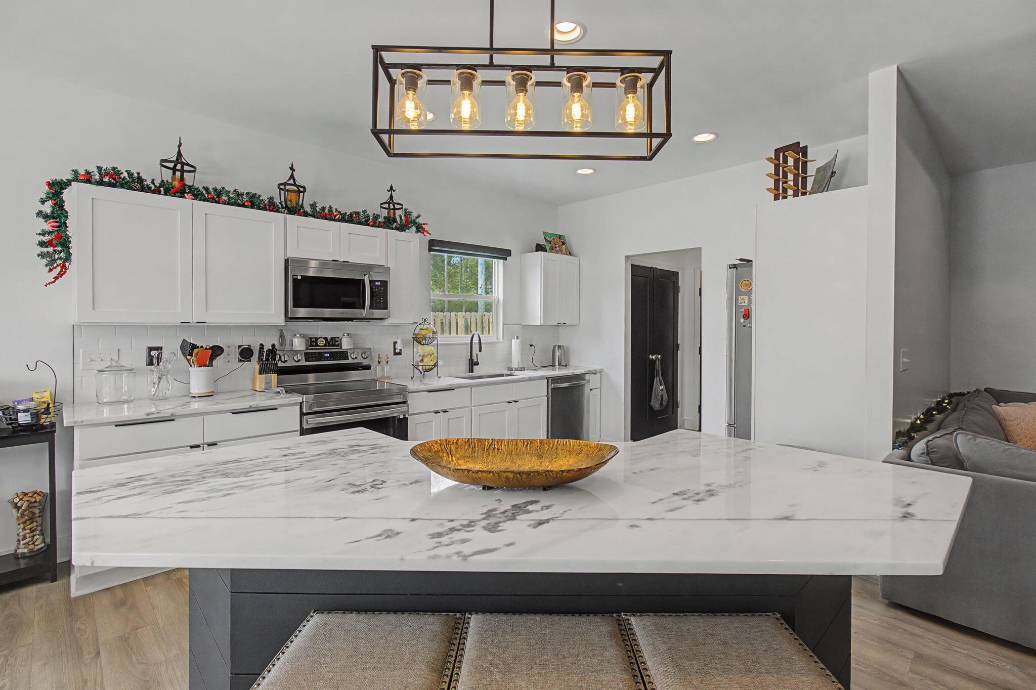 197 West 1st Avenue Crestview, FL 32536 - Photo 9 of 32 a kitchen with a table chairs and microwave