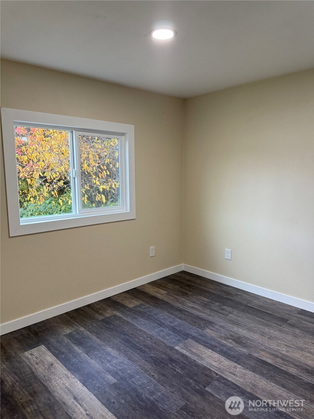 2610 Calawah Way, Unit 33 Forks, WA 98331 - Photo 3 of 14 a view of an empty room with wooden floor and a window