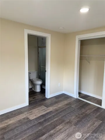 a view of a room with wooden floor and bathroom