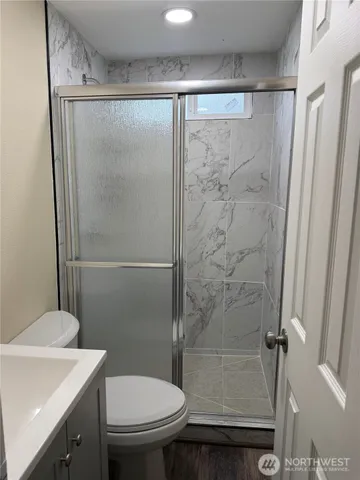a bathroom with a shower and a toilet