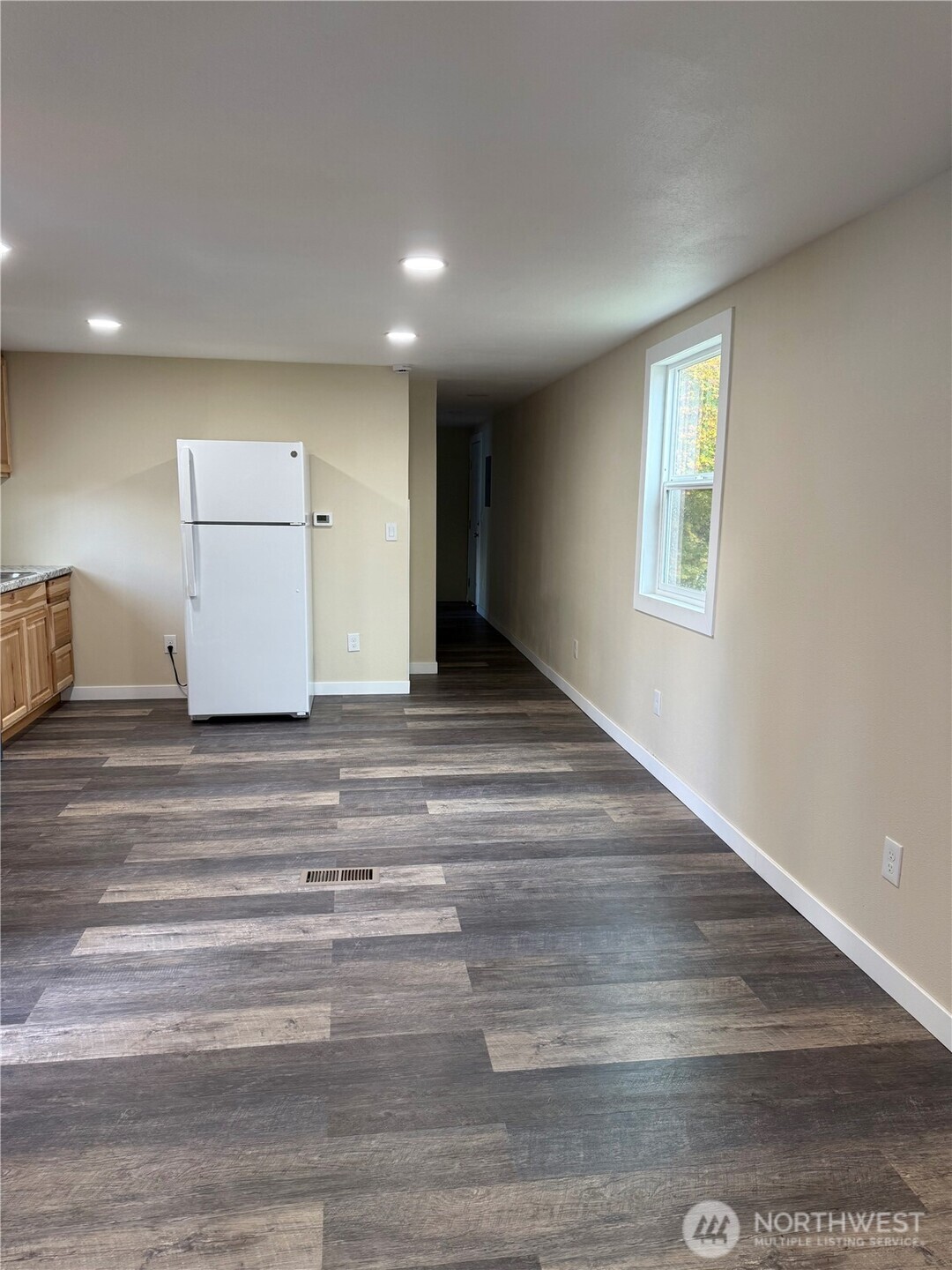 2610 Calawah Way, Unit 33 Forks, WA 98331 - Photo 10 of 14 a view of an empty room with wooden floor and a window