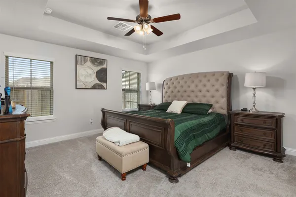 a bedroom with a bed and a chandelier