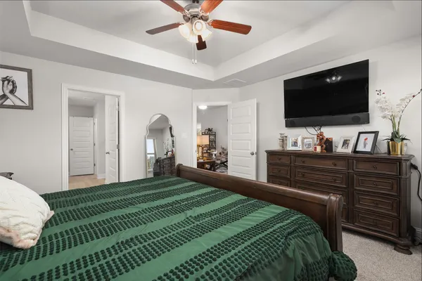 a bedroom with a bed and a flat screen tv