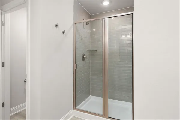 a bathroom with a glass shower door