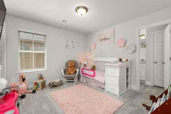 a bedroom with furniture and a window
