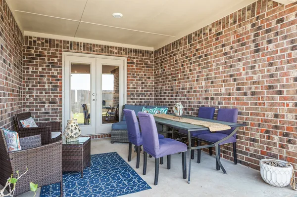 a backyard of a house with table and chairs