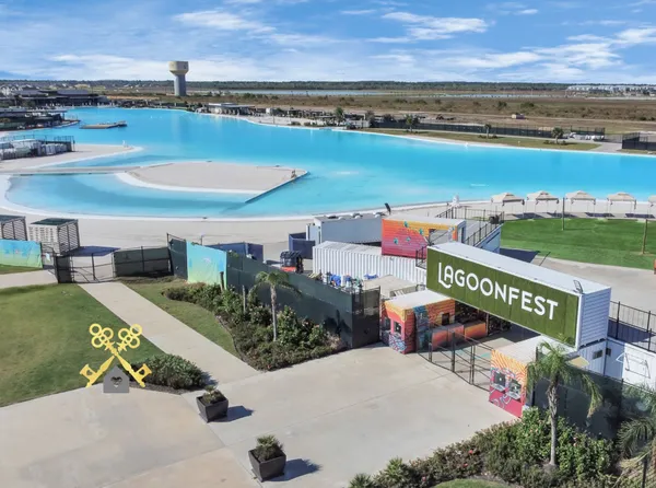an aerial view of a swimming pool with a yard