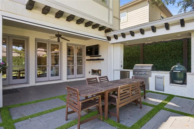 a view of a deck with table and chairs with wooden floor and fence