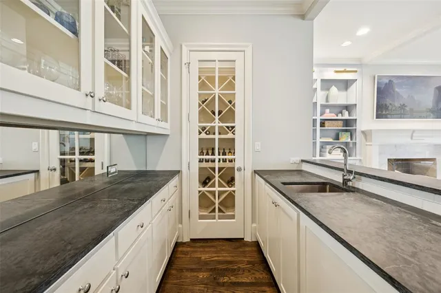 a kitchen with granite countertop a sink and a stove