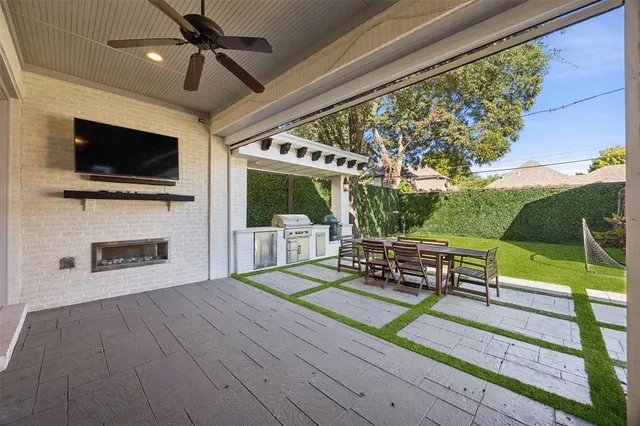 a view of a patio with dining table and chairs with a flat screen tv