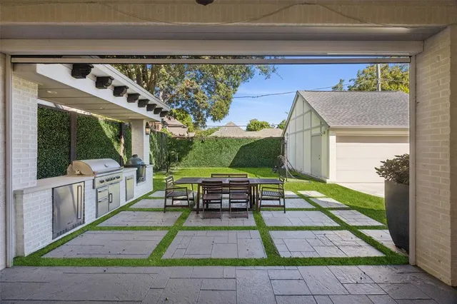a view of a patio with table and chairs with wooden floor and fence