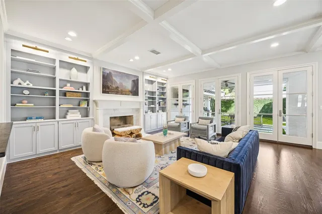 a living room with furniture fireplace and wooden floor