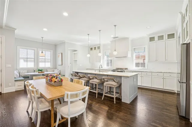 a large kitchen with a table and chairs
