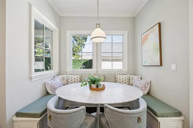 a dining room with furniture a window and a table