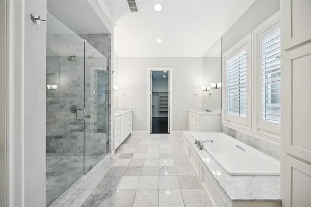 a bathroom with a tub shower and sink