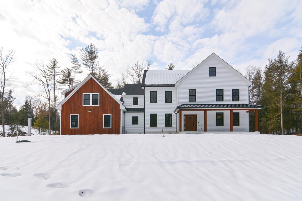 a view of a white house with a yard