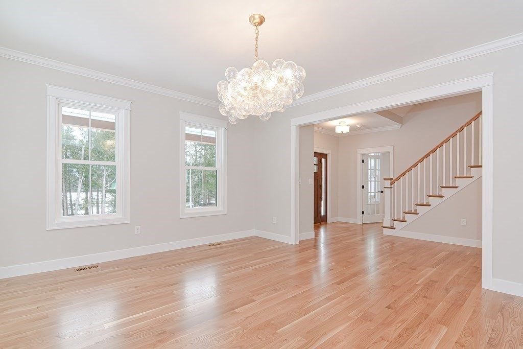Lot 7 Maple Avenue Groton, MA 01450 - Photo 13 of 42 a view of an empty room with wooden floor and a window